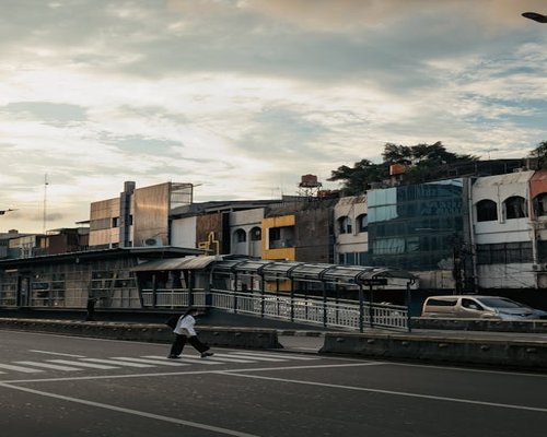 Person walking comfortably on a Lima sidewalk during sunset